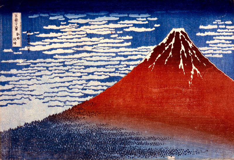 Fine Wind, Clear Morning by Hokusai: Mount Fuji in deep red under a blue sky of small white clouds, dark forest below
