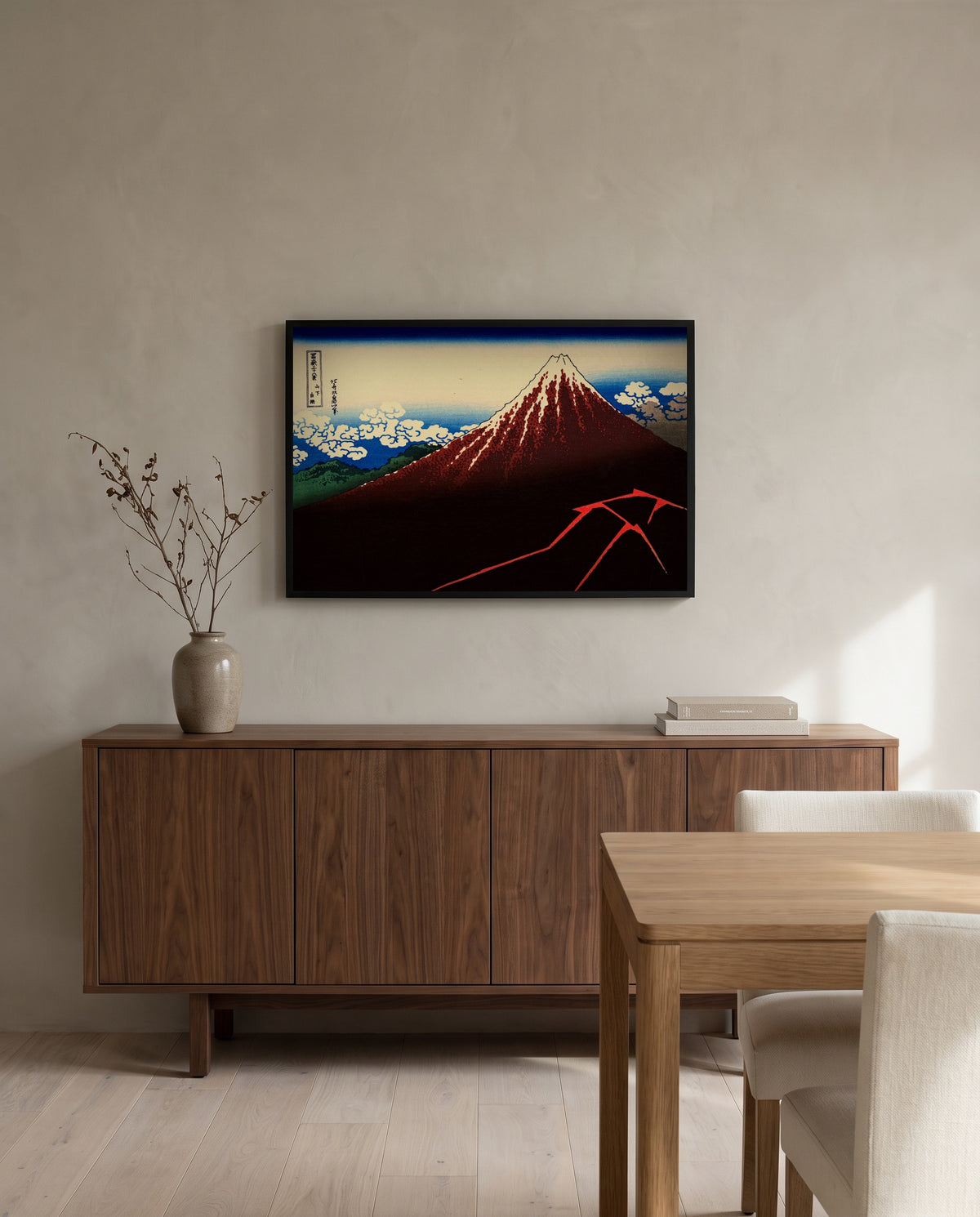 Thunderstorm Beneath the Summit by Katsushika Hokusai in a black frame above a walnut sideboard in a dining room