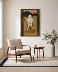 Frost by Hugo Simberg as a stretched canvas above a linen lounge chair in a reading corner