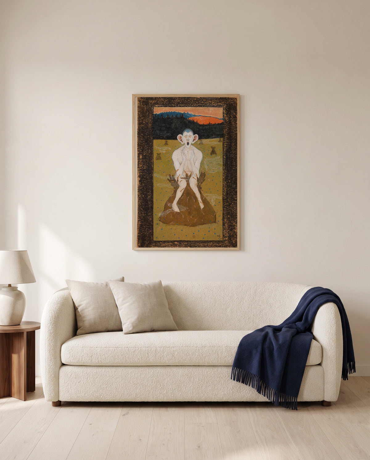Frost by Hugo Simberg framed in natural oak above a cream sofa in a warm living room