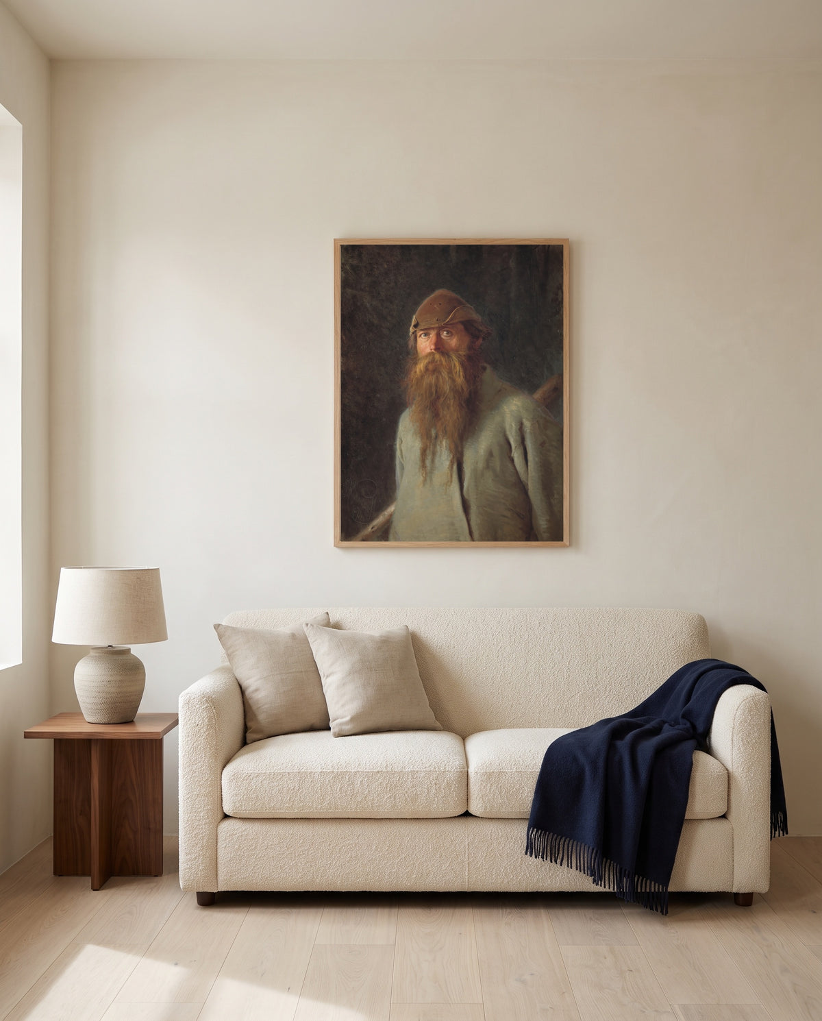Forester by Ivan Kramskoi framed in natural oak above a cream sofa in a warm living room