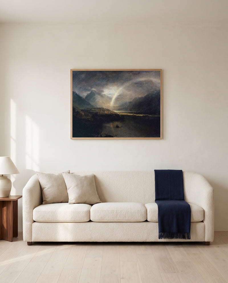 Buttermere Lake by J. M. W. Turner framed in natural oak above a cream sofa in a warm living room