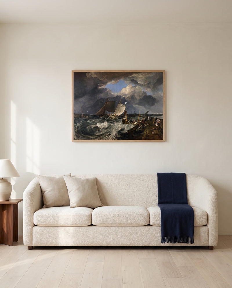 Calais Pier by J. M. W. Turner framed in natural oak above a cream sofa in a warm living room