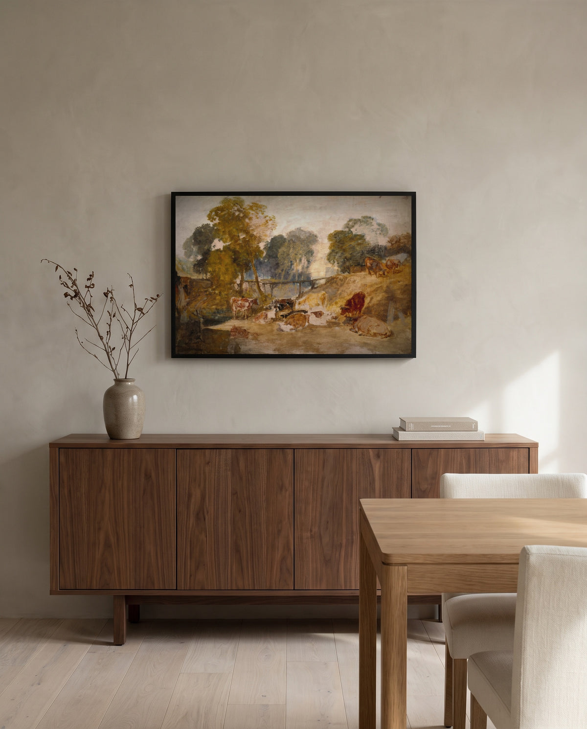 Cows with a Footbridge by J. M. W. Turner in a black frame above a walnut sideboard in a dining room