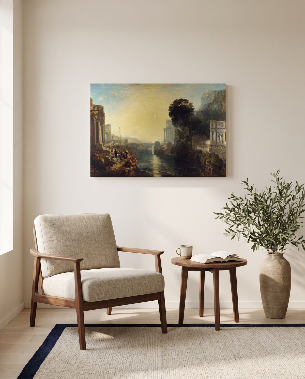 Dido building Carthage by J. M. W. Turner as a stretched canvas above a linen lounge chair in a reading corner