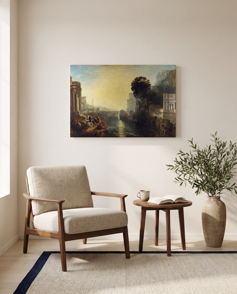 Dido building Carthage by J. M. W. Turner as a stretched canvas above a linen lounge chair in a reading corner