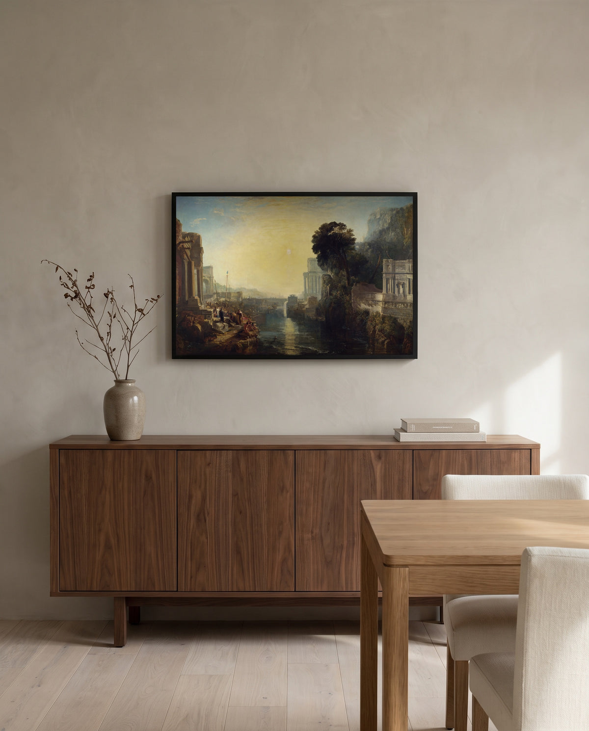Dido building Carthage by J. M. W. Turner in a black frame above a walnut sideboard in a dining room