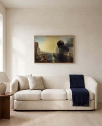 Dido building Carthage by J. M. W. Turner framed in natural oak above a cream sofa in a warm living room