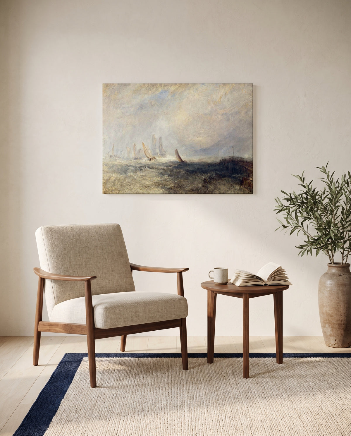 Port Ruysdael by J. M. W. Turner as a stretched canvas above a linen lounge chair in a reading corner