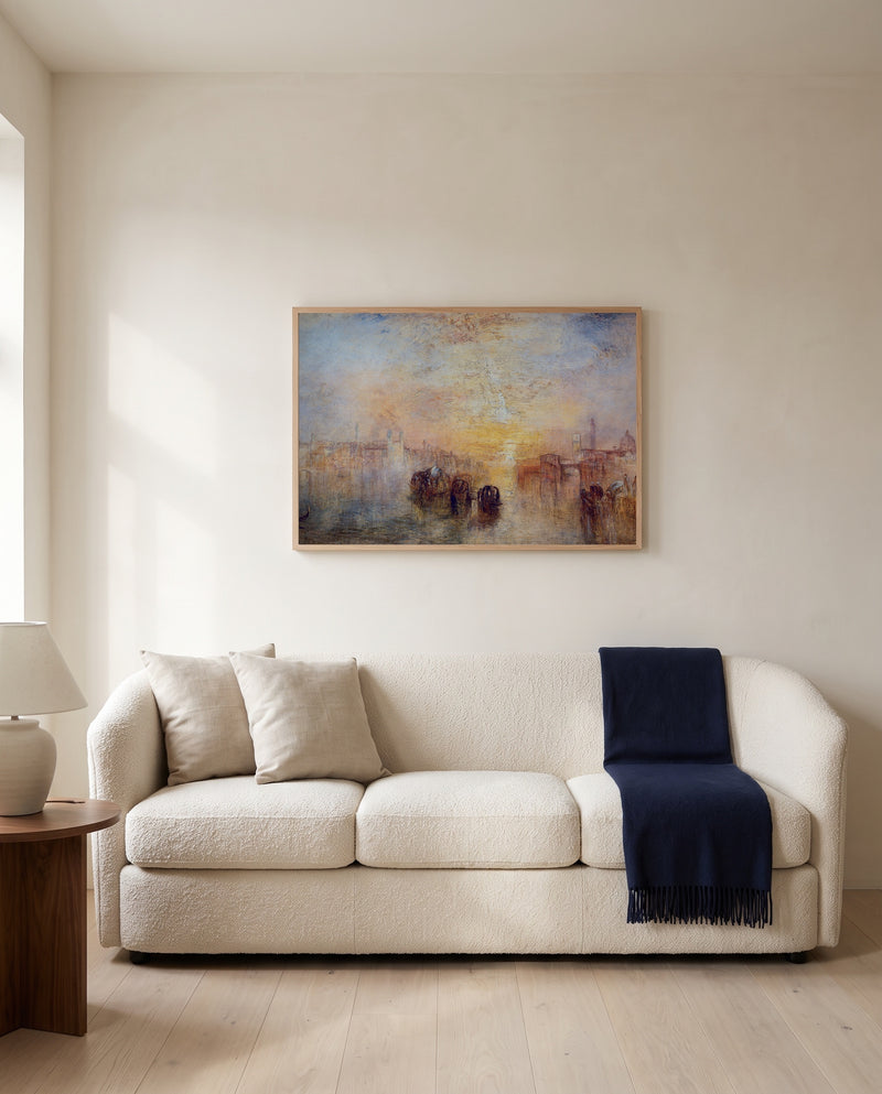 Going to the Ball by J. M. W. Turner framed in natural oak above a cream sofa in a warm living room