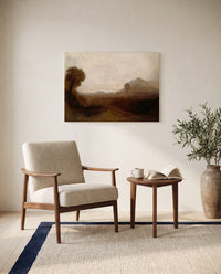 Italian Landscape with Tower by J. M. W. Turner as a stretched canvas above a linen lounge chair in a reading corner