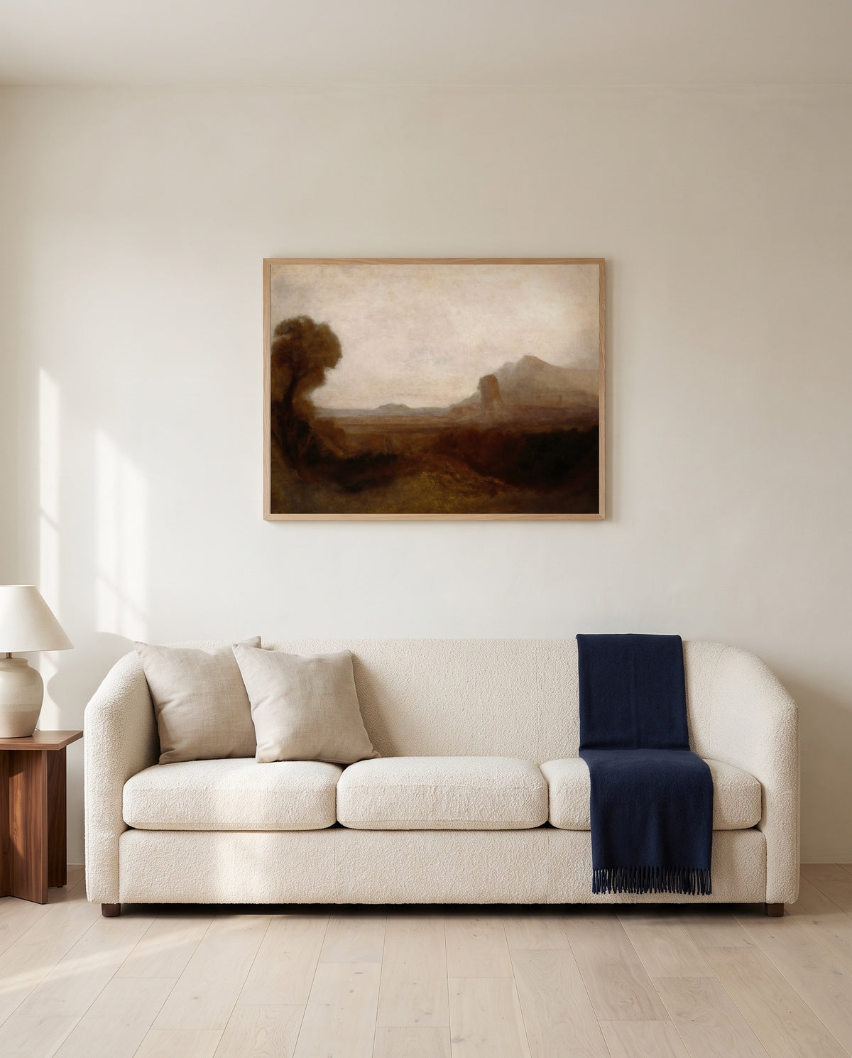 Italian Landscape with Tower by J. M. W. Turner framed in natural oak above a cream sofa in a warm living room