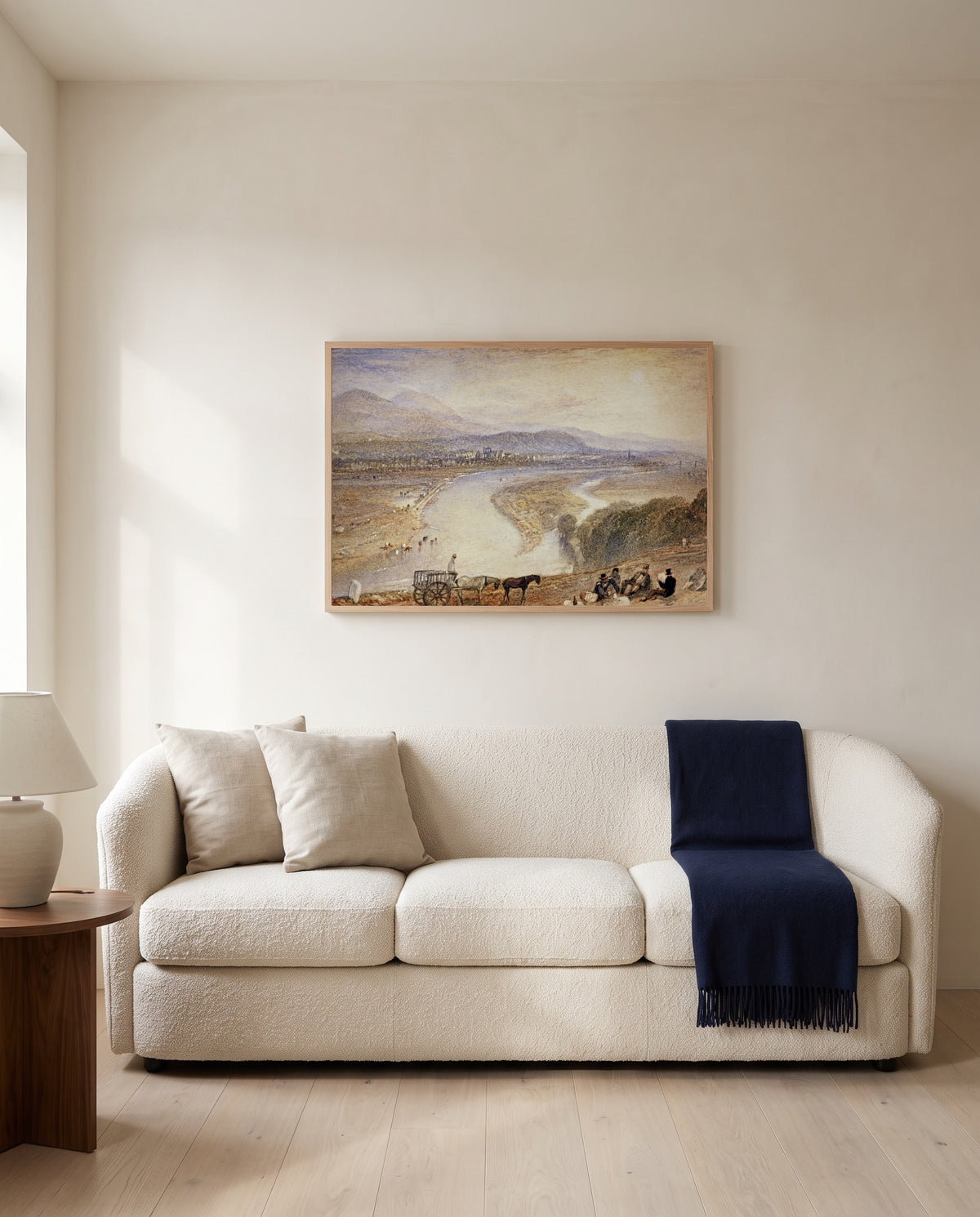 Melrose by J. M. W. Turner framed in natural oak above a cream sofa in a warm living room