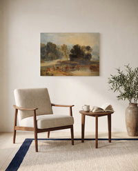 Horses Crossing a River by J. M. W. Turner as a stretched canvas above a linen lounge chair in a reading corner