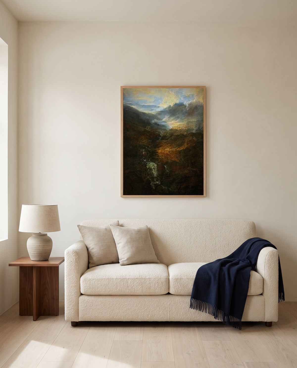Morning, Coniston Fells by J. M. W. Turner framed in natural oak above a cream sofa in a warm living room