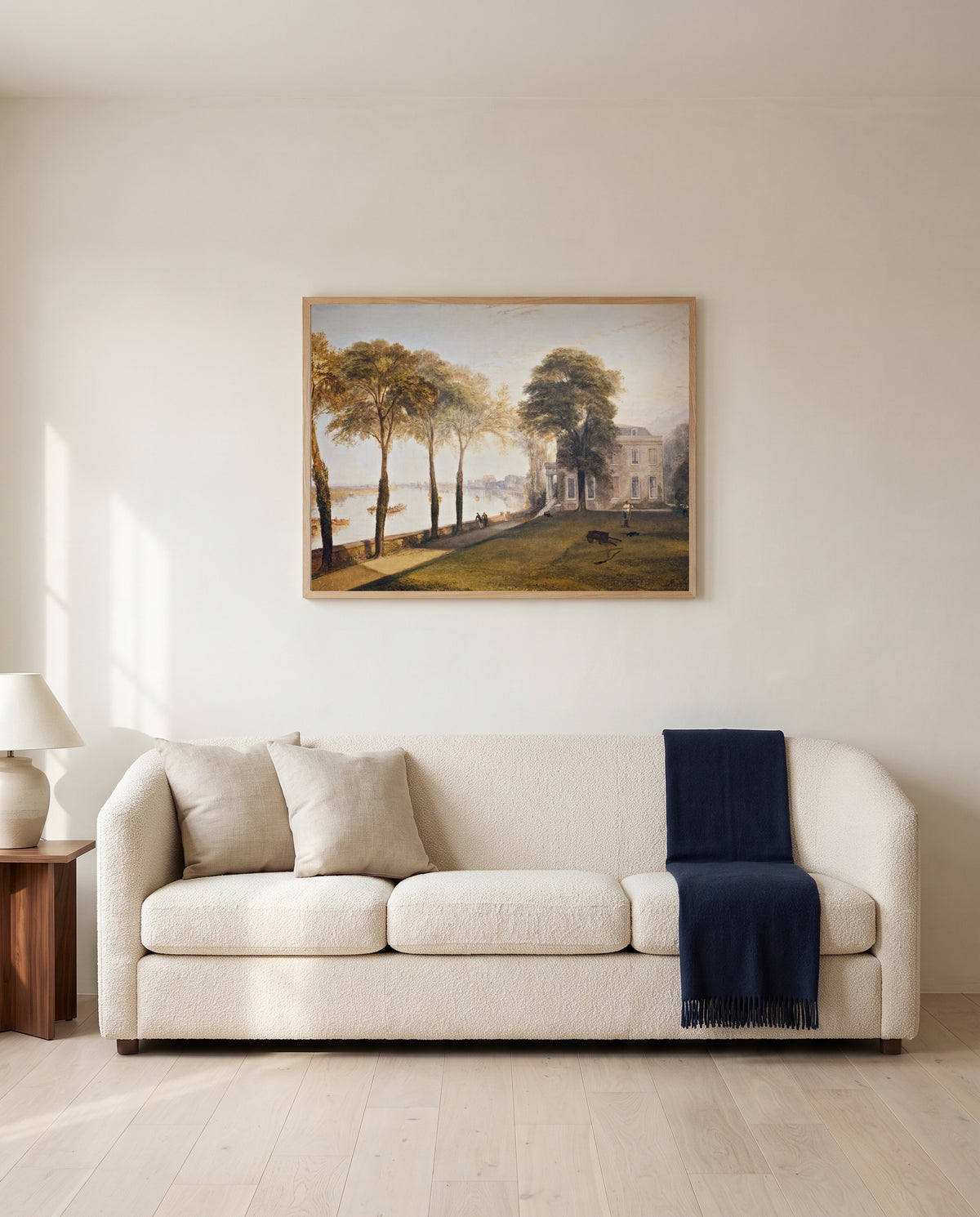 Mortlake Terrace by J. M. W. Turner framed in natural oak above a cream sofa in a warm living room