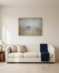 Norham Castle, Sunrise by J. M. W. Turner framed in natural oak above a cream sofa in a warm living room