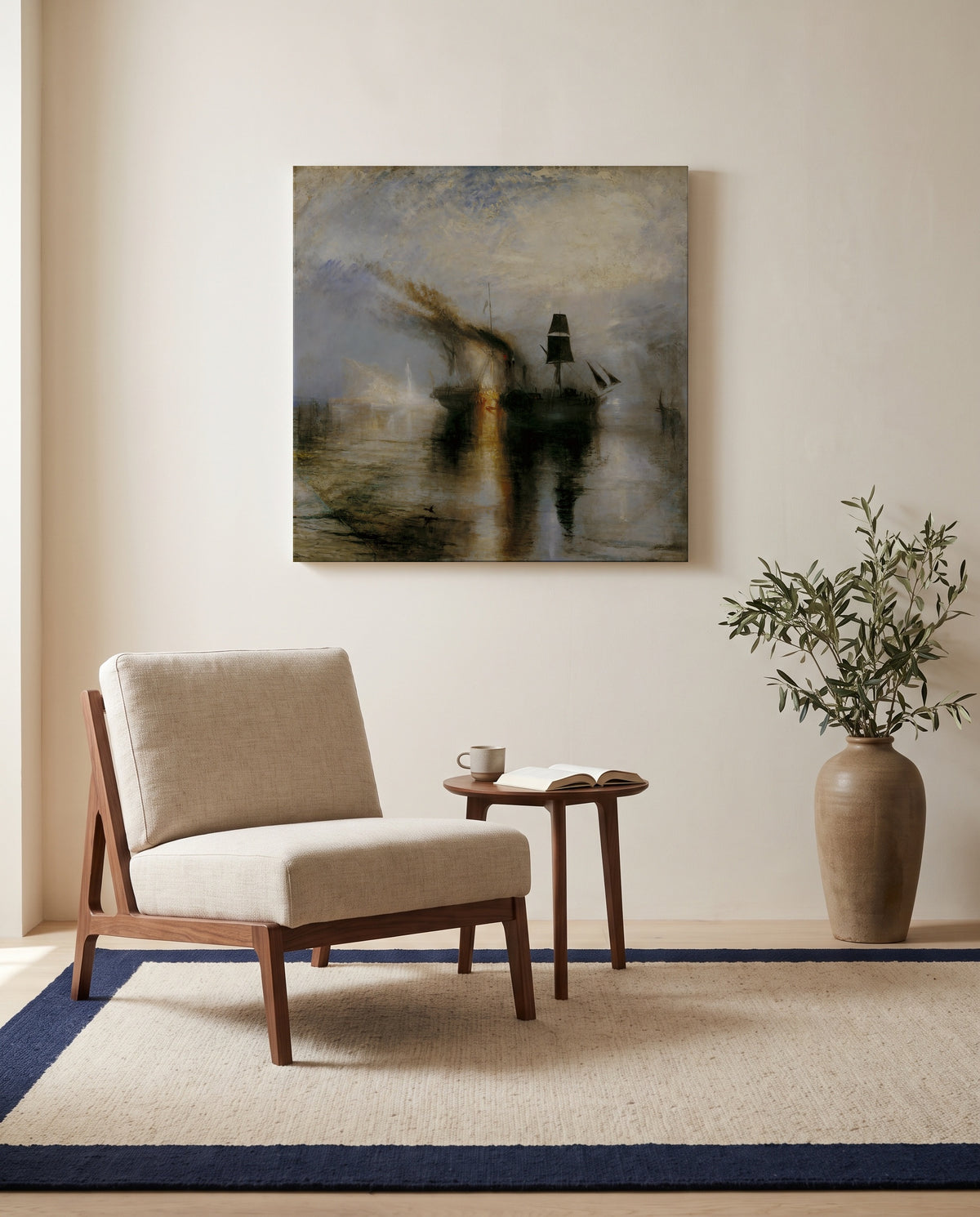 Peace – Burial at Sea by J. M. W. Turner as a stretched canvas above a linen lounge chair in a reading corner