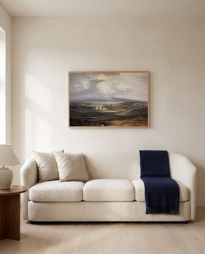 Raby Castle by J. M. W. Turner framed in natural oak above a cream sofa in a warm living room