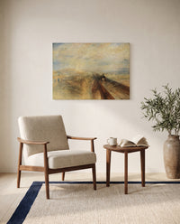 Rain, Steam and Speed by J. M. W. Turner as a stretched canvas above a linen lounge chair in a reading corner