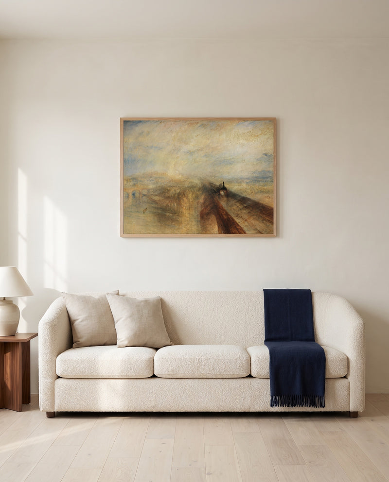Rain, Steam and Speed by J. M. W. Turner framed in natural oak above a cream sofa in a warm living room