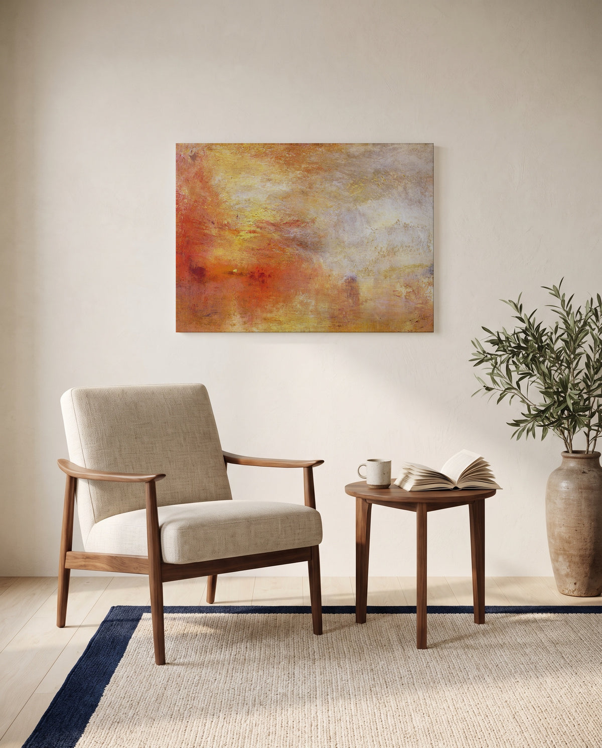 Sun Setting over a Lake by J. M. W. Turner as a stretched canvas above a linen lounge chair in a reading corner