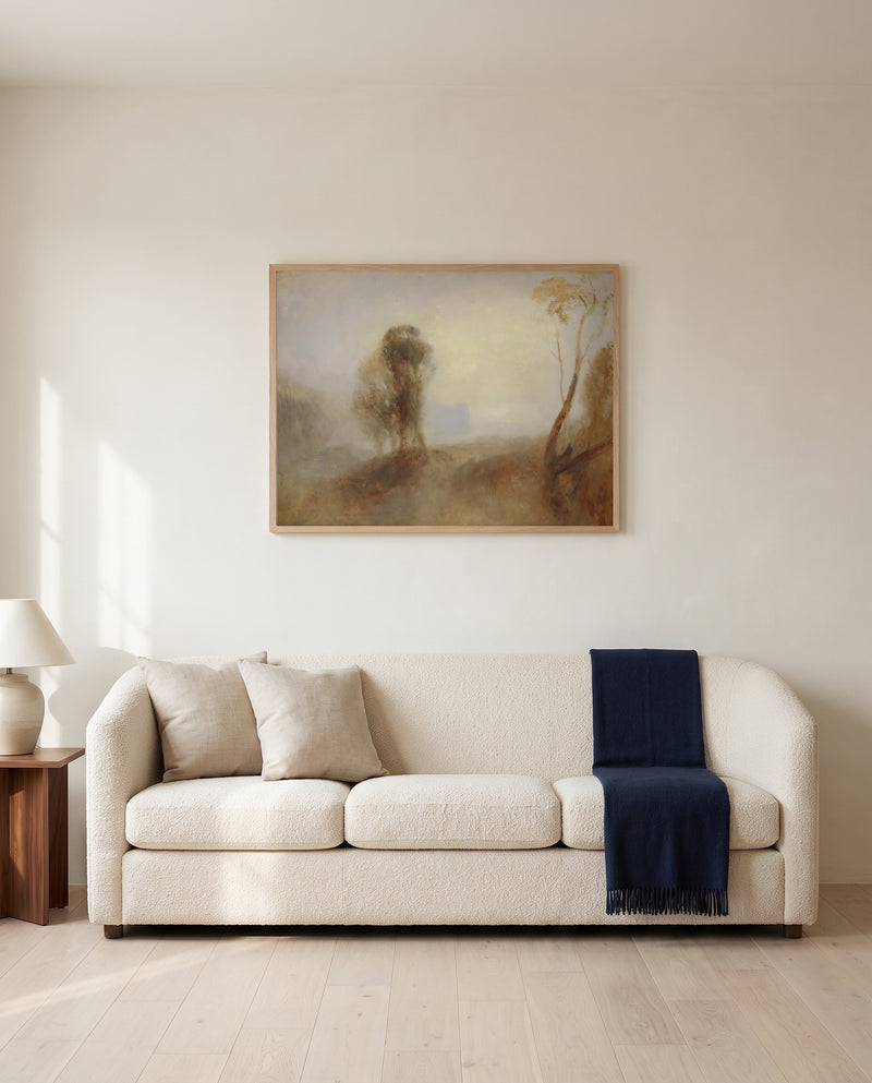 Castle on a Bay: Solitude by J. M. W. Turner framed in natural oak above a cream sofa in a warm living room