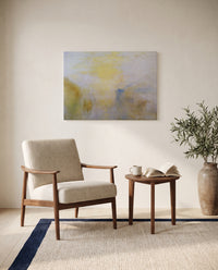 Boat between Headlands by J. M. W. Turner as a stretched canvas above a linen lounge chair in a reading corner