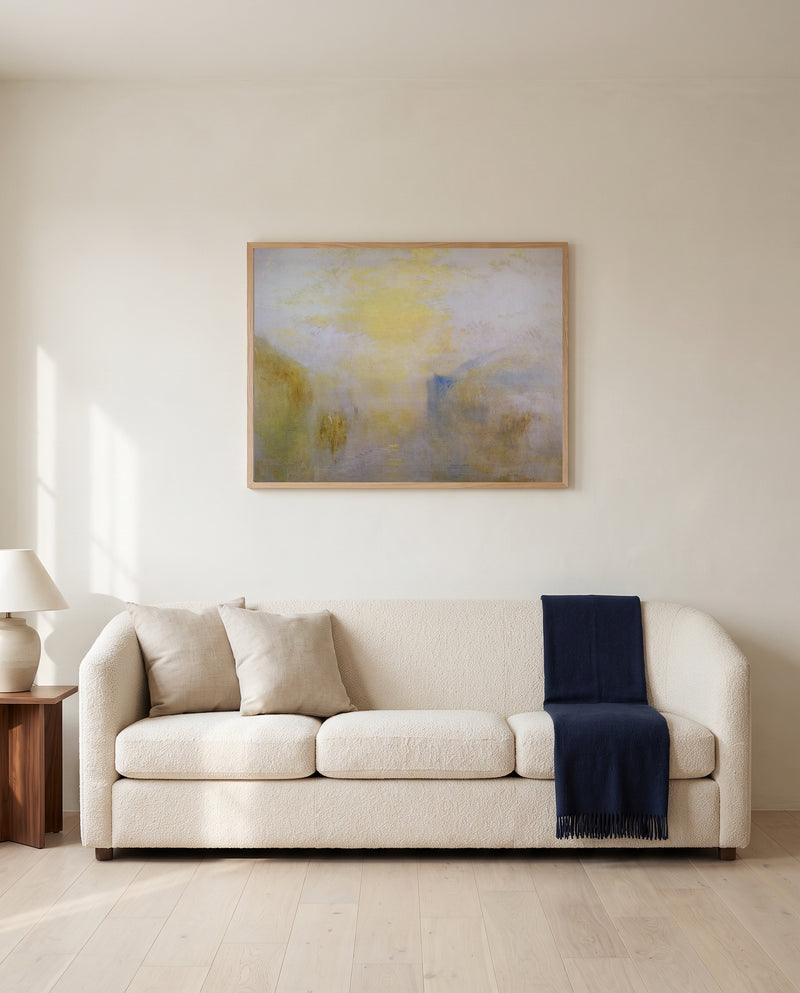 Boat between Headlands by J. M. W. Turner framed in natural oak above a cream sofa in a warm living room