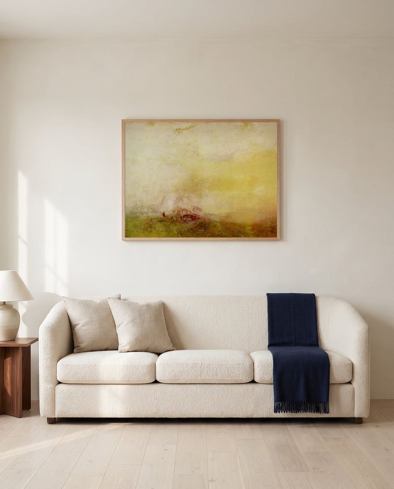 Sunrise with Sea Monsters by J. M. W. Turner framed in natural oak above a cream sofa in a warm living room