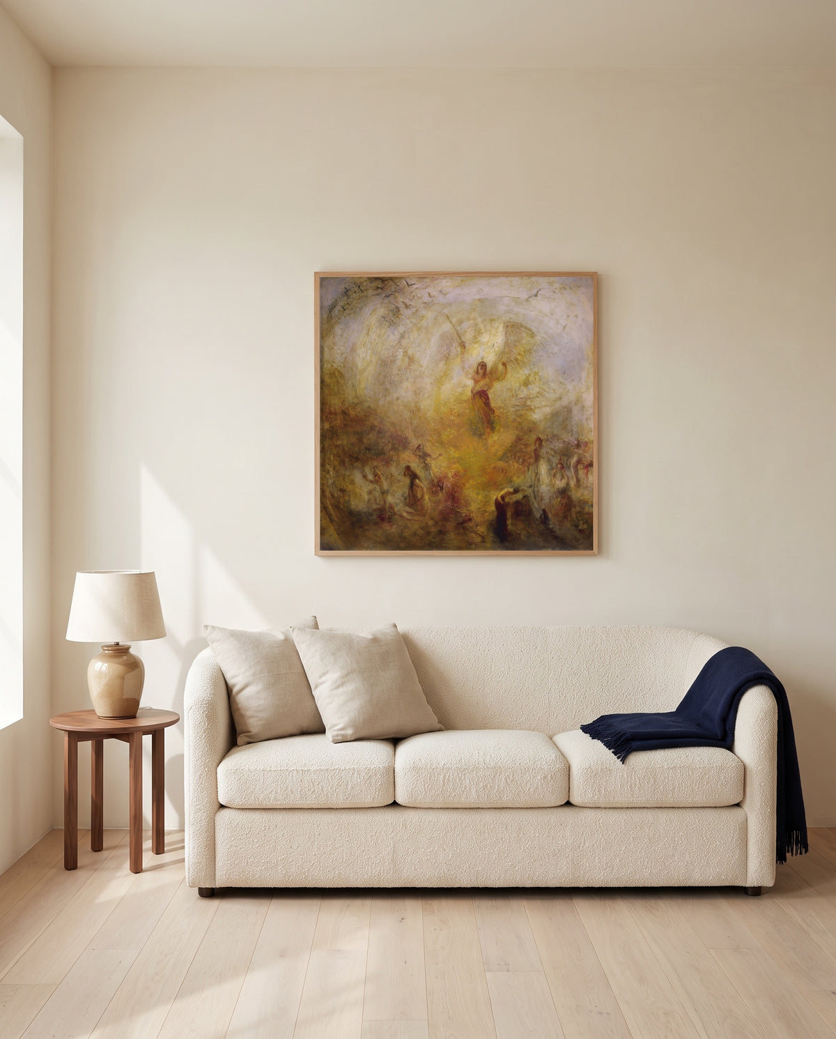 The Angel Standing in the Sun by J. M. W. Turner framed in natural oak above a cream sofa in a warm living room