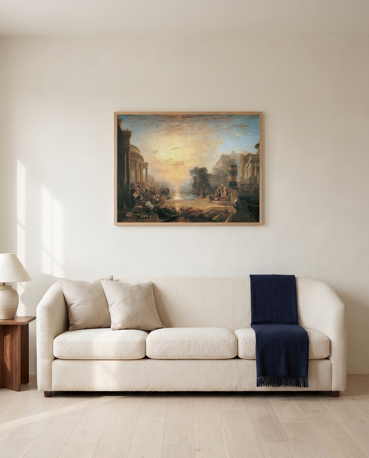 Decline of Carthage by J. M. W. Turner framed in natural oak above a cream sofa in a warm living room