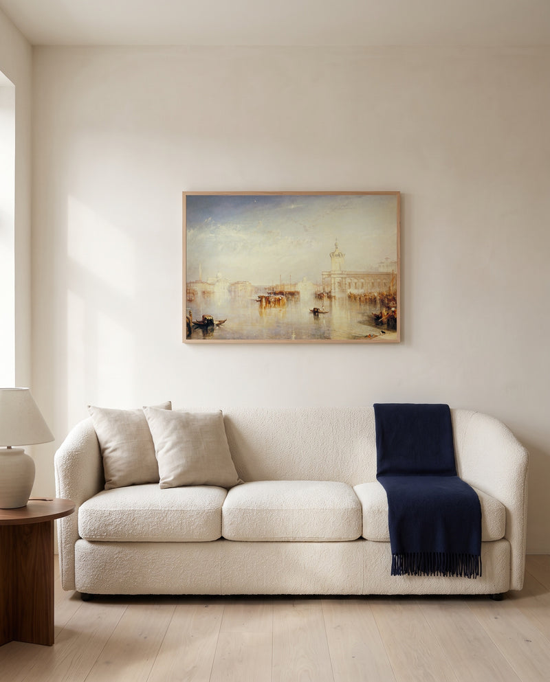 The Dogana, Venice by J. M. W. Turner framed in natural oak above a cream sofa in a warm living room