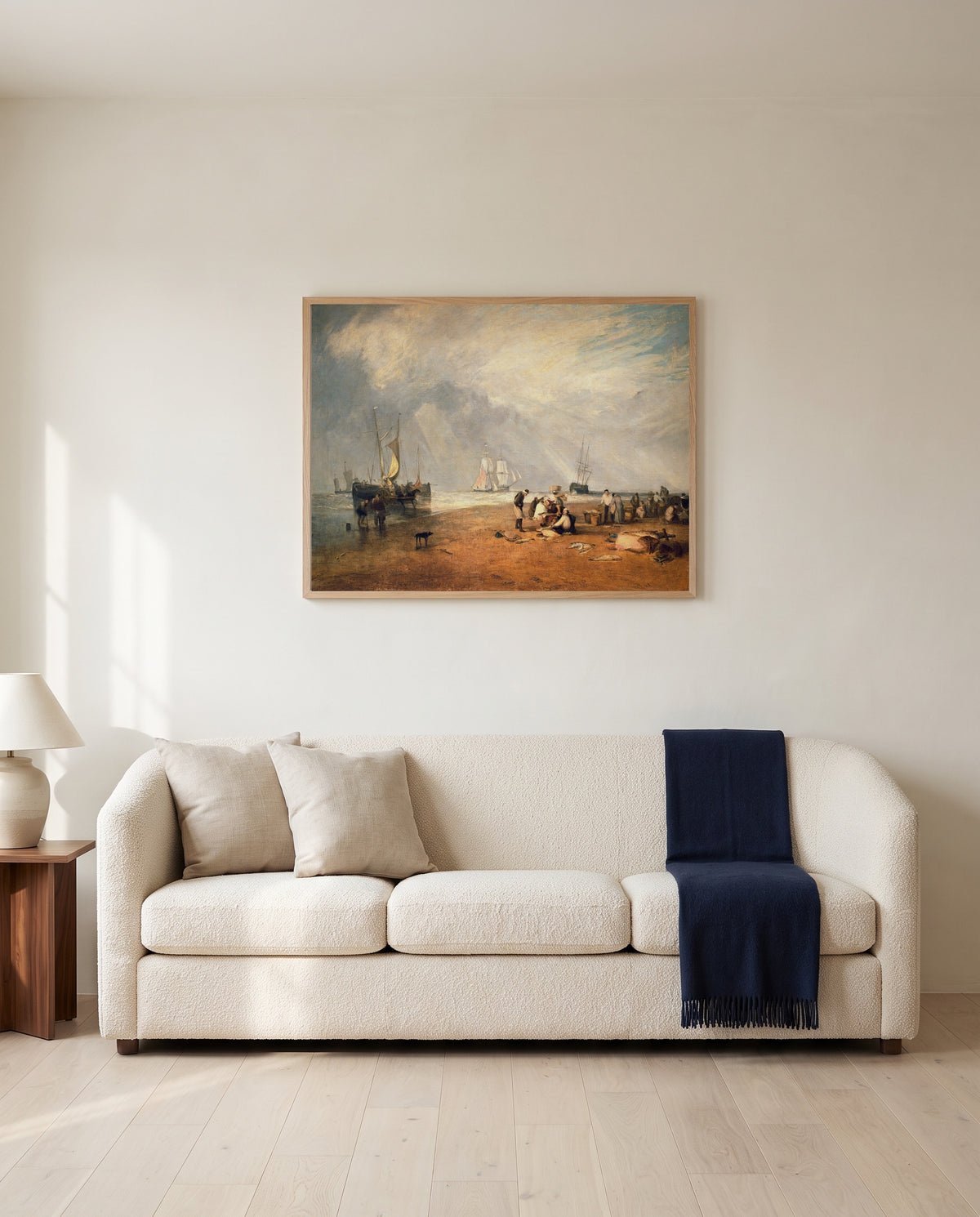 Fish Market at Hastings by J. M. W. Turner framed in natural oak above a cream sofa in a warm living room