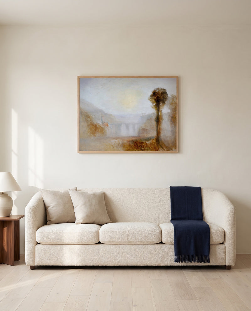 Ponte delle Torri, Spoleto by J. M. W. Turner framed in natural oak above a cream sofa in a warm living room
