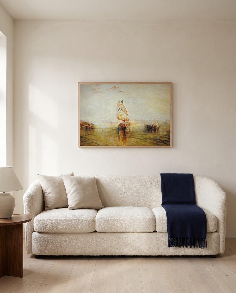 The Sun of Venice by J. M. W. Turner framed in natural oak above a cream sofa in a warm living room