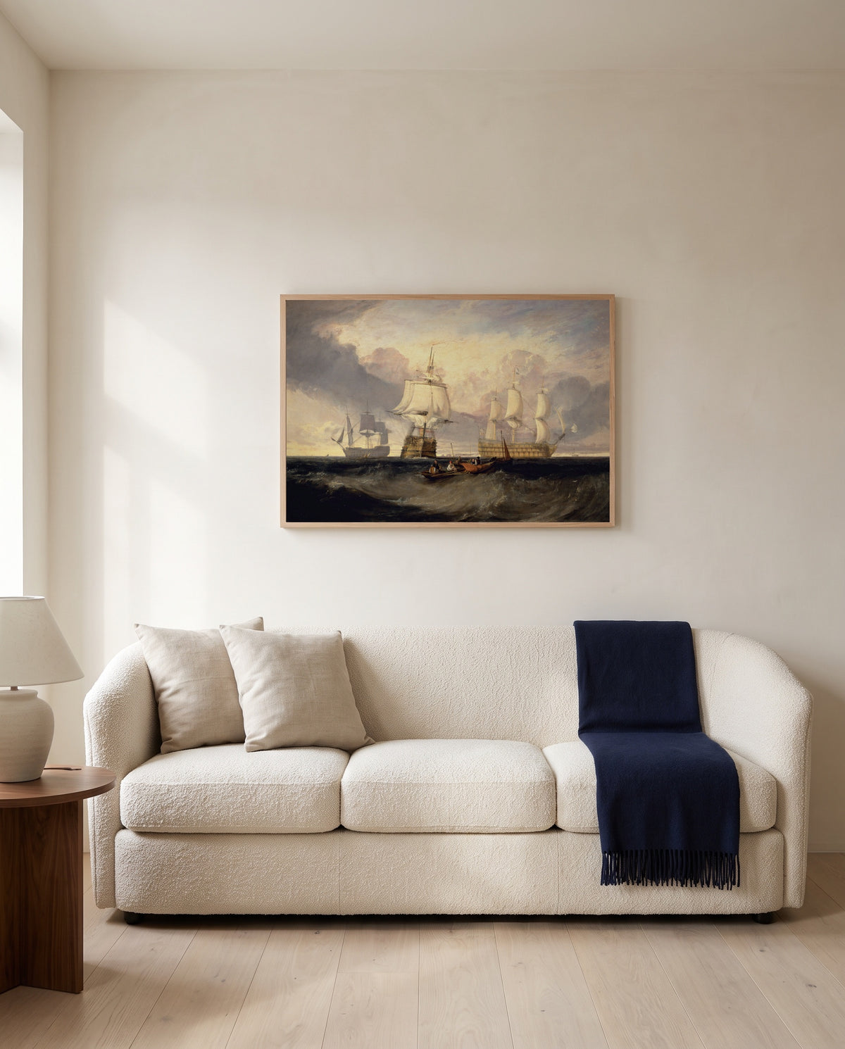 Victory from Trafalgar by J. M. W. Turner framed in natural oak above a cream sofa in a warm living room