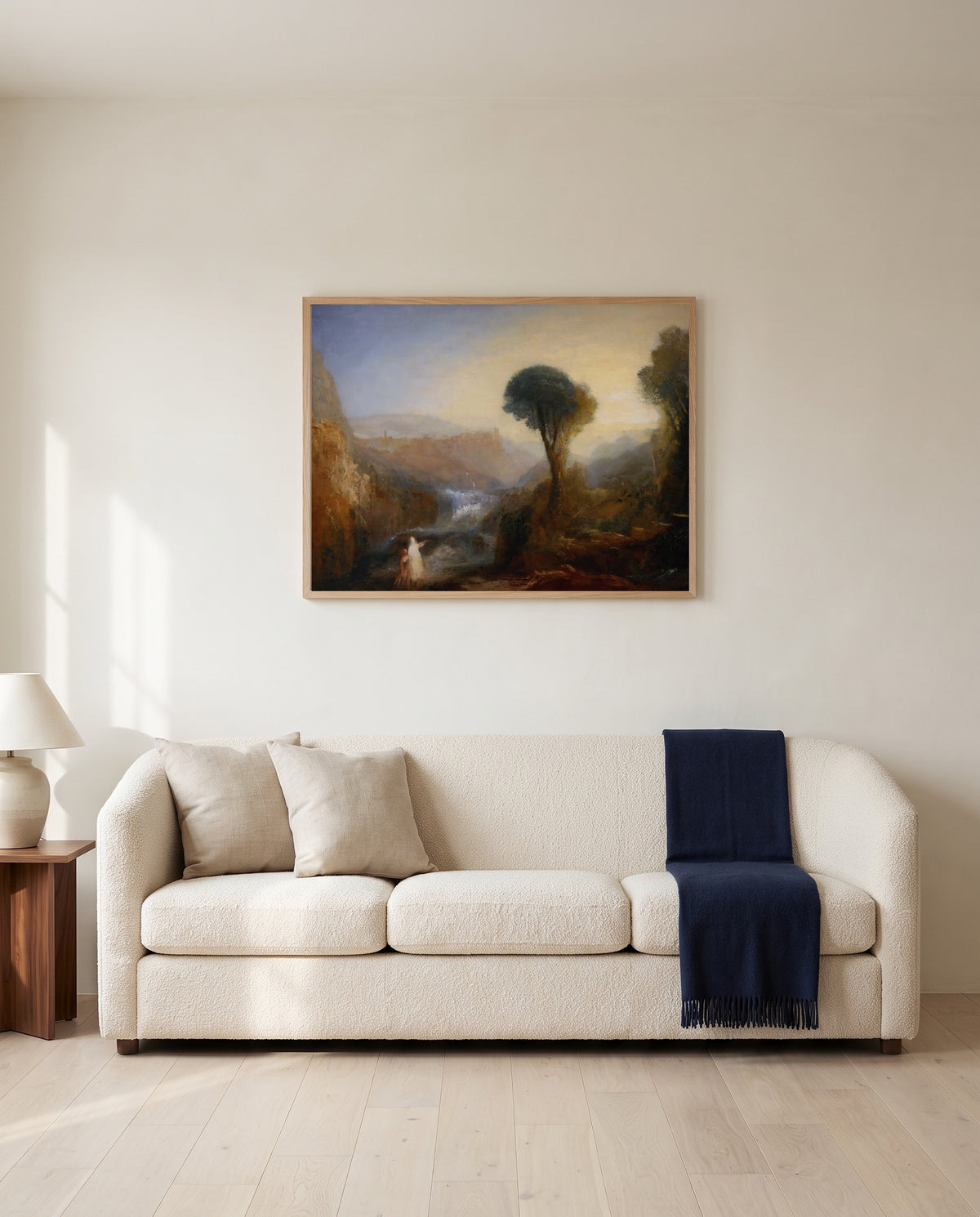Tobias and the Angel by J. M. W. Turner framed in natural oak above a cream sofa in a warm living room