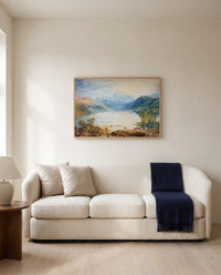 Ullswater by J. M. W. Turner framed in natural oak above a cream sofa in a warm living room