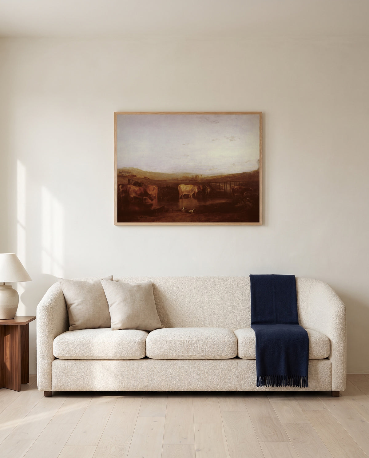 Union of the Thames and Isis by J. M. W. Turner framed in natural oak above a cream sofa in a warm living room