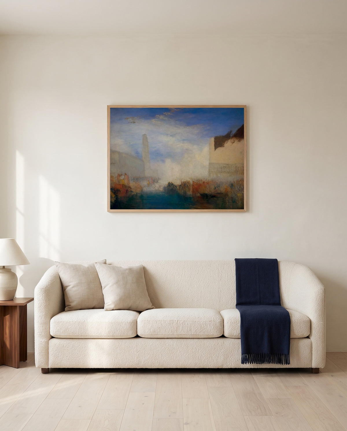 Doge Marrying the Sea by J. M. W. Turner framed in natural oak above a cream sofa in a warm living room