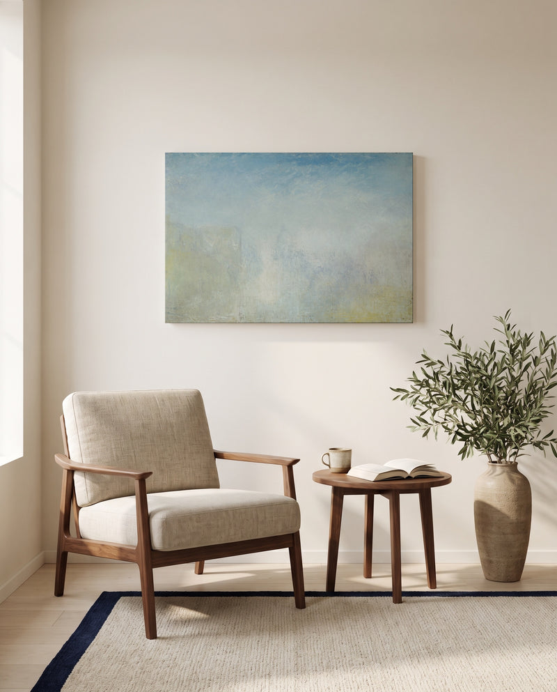 Venice with the Salute by J. M. W. Turner as a stretched canvas above a linen lounge chair in a reading corner