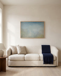 Venice with the Salute by J. M. W. Turner framed in natural oak above a cream sofa in a warm living room