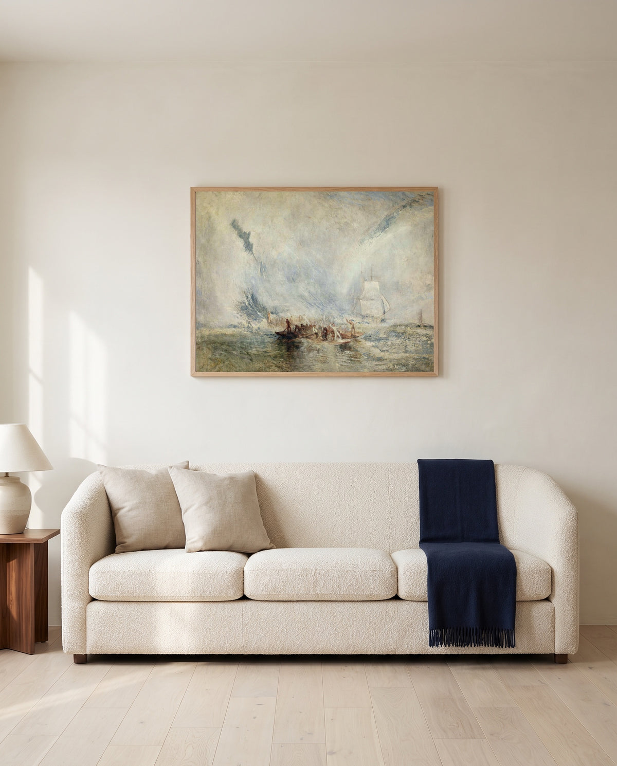 Whalers by J. M. W. Turner framed in natural oak above a cream sofa in a warm living room