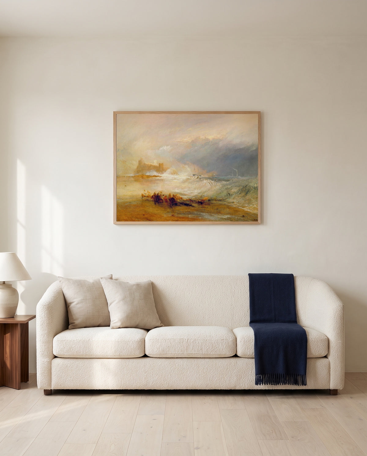 Wreckers, Northumberland by J. M. W. Turner framed in natural oak above a cream sofa in a warm living room