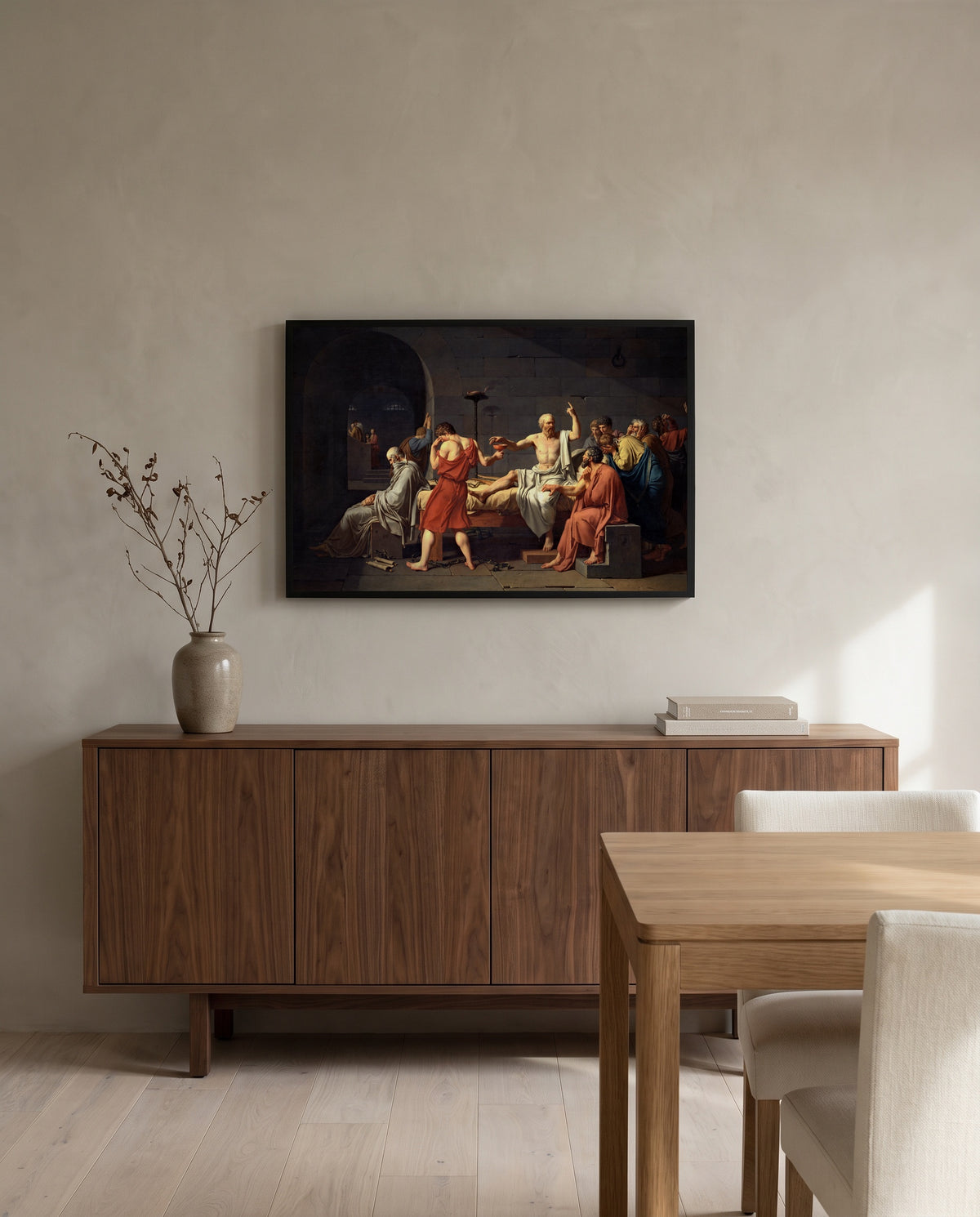 The Death of Socrates by Jacques-Louis David in a black frame above a walnut sideboard in a dining room