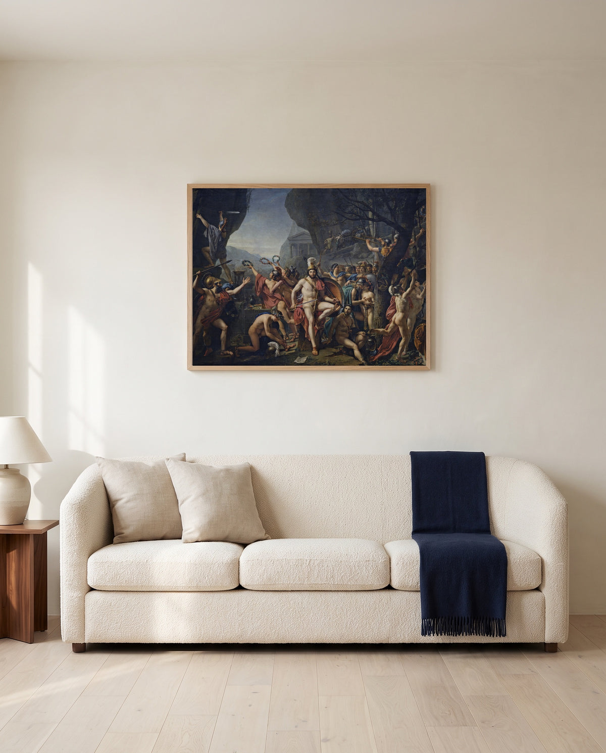 Leonidas at Thermopylae by Jacques-Louis David framed in natural oak above a cream sofa in a warm living room