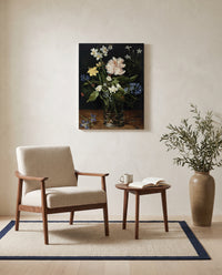 Flowers in a Glass by Jan Brueghel the Elder as a stretched canvas above a linen lounge chair in a reading corner