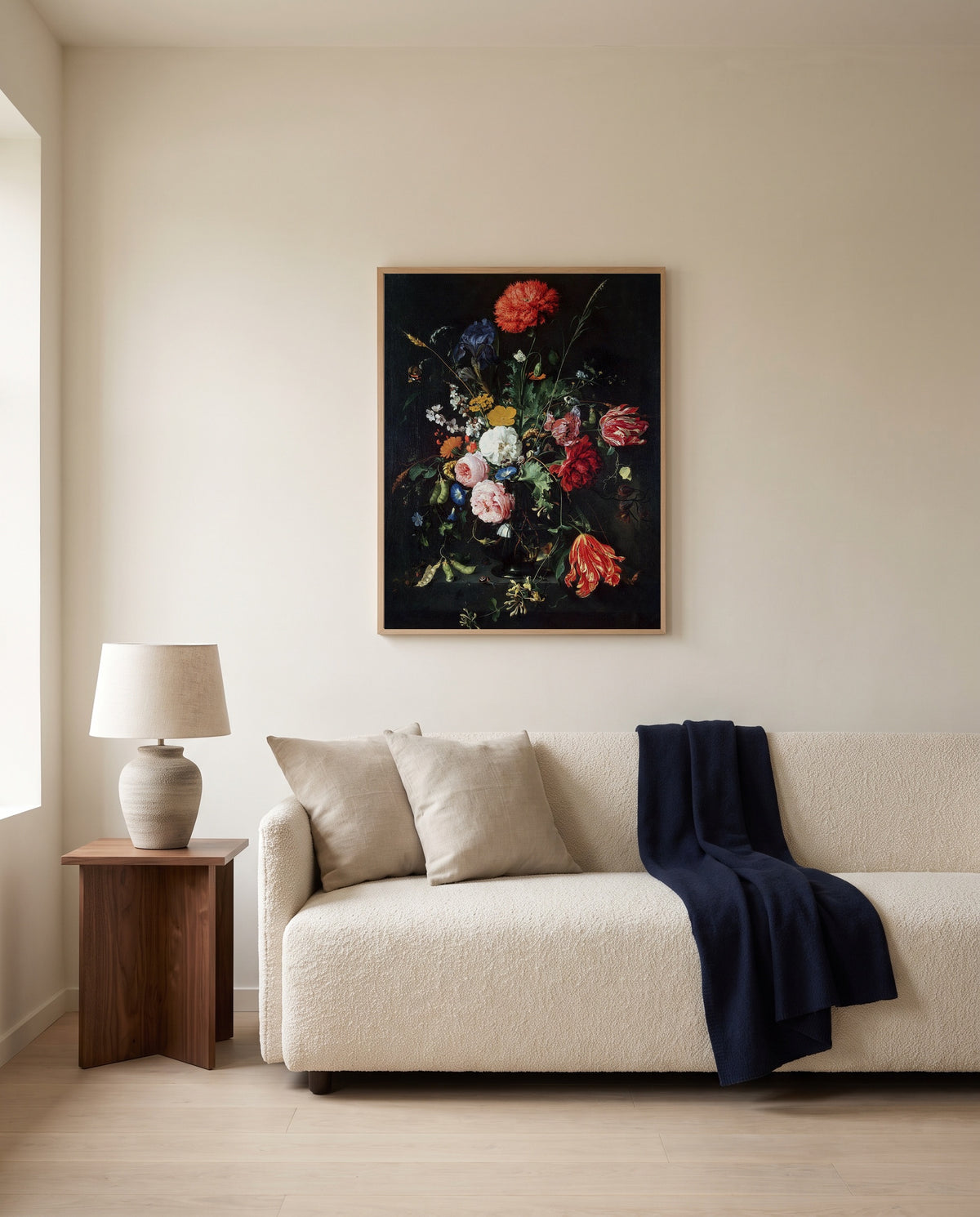 Flowers in a Glass Vase (1670) by Jan Davidsz. de Heem framed in natural oak above a cream sofa in a warm living room
