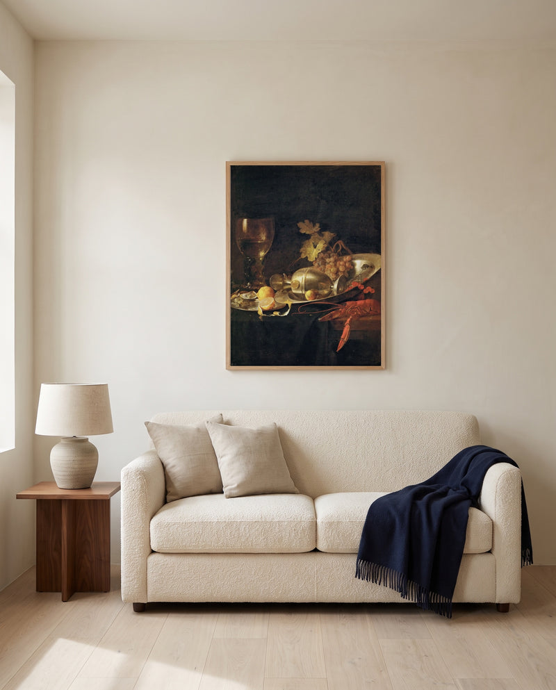 Roemer and a Lobster by Jan Davidsz. de Heem framed in natural oak above a cream sofa in a warm living room